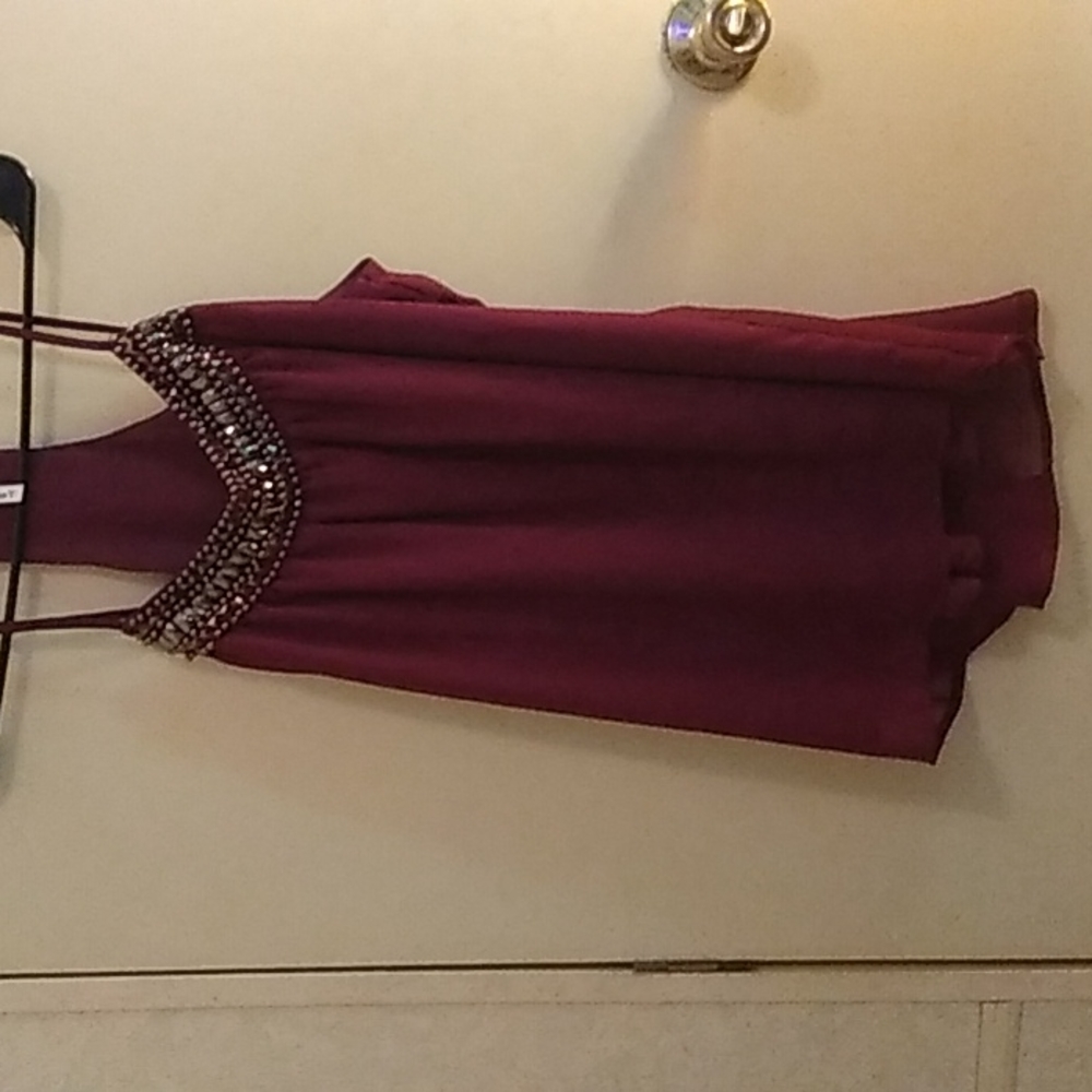 Sheer sleeveless top with beading across neckline